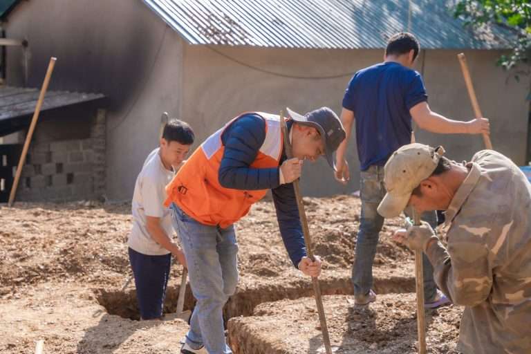 Workers digging foundation trenches on a building site