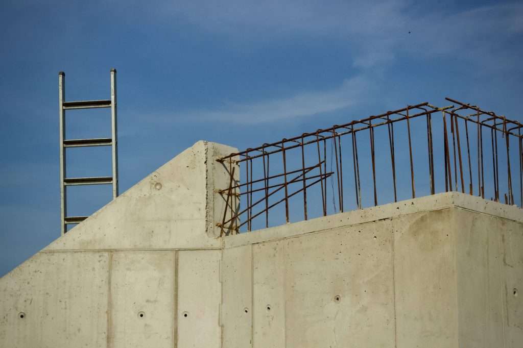 Reinforced concrete structure under construction with exposed rebar