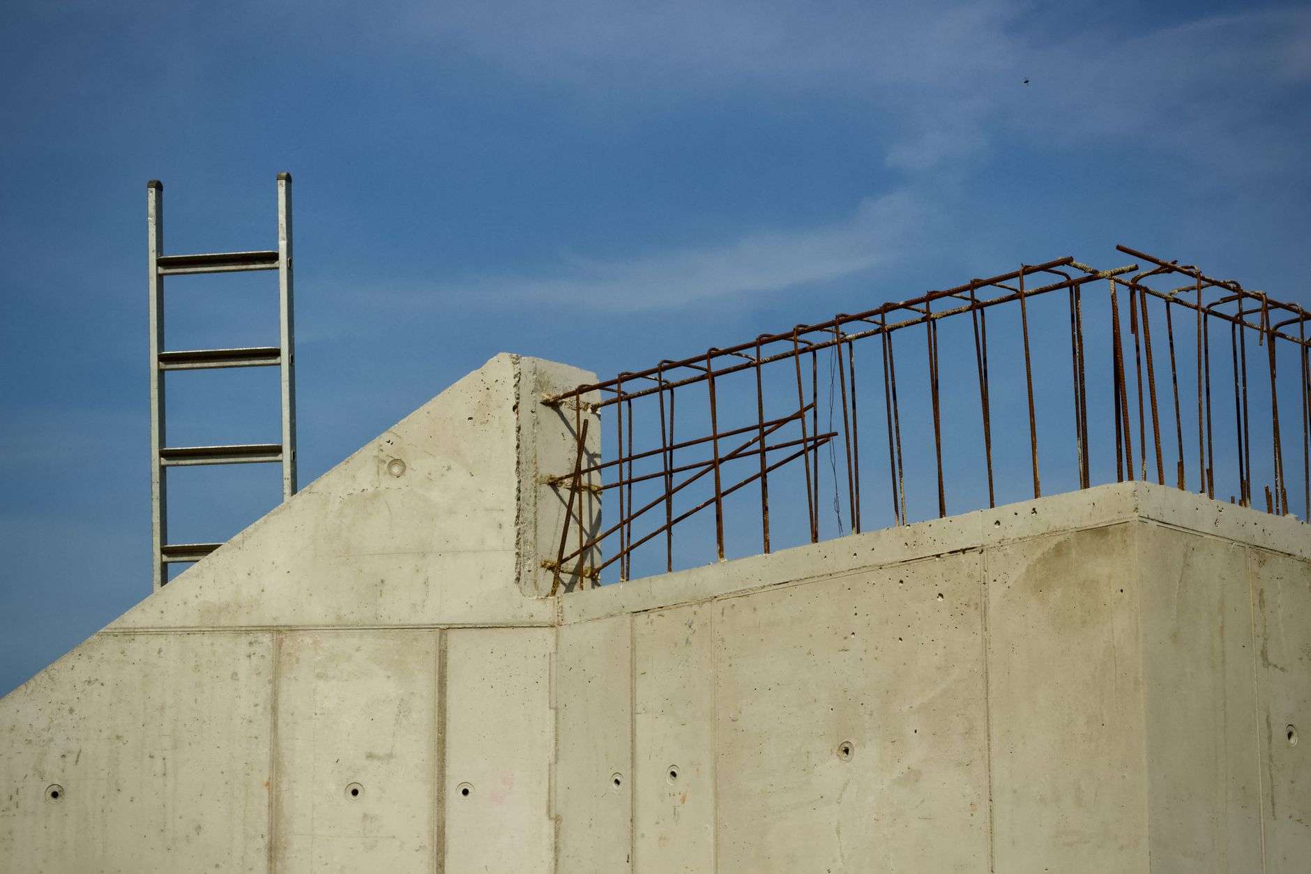 Reinforced concrete structure under construction with exposed rebar